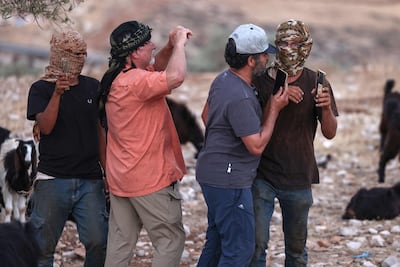 Masked Israeli settlers scuffle with foreign activists at the Kaabneh Bedouin community, east of Taybeh, northeast of Ramallah, in the occupied West Bank. AFP