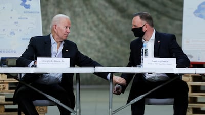 Mr Biden and Polish President Andrzej Duda attend a briefing on humanitarian efforts for Ukraine, near Rzeszow, Poland. Reuters