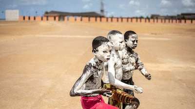 Children covered in white paint pose for a photograph near the Door of No Return in Ouidah, Benin. The memorial to enslaved Africans marks the point where they were forced on to transatlantic slave ships. AFP