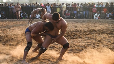 Participants compete in a bout of traditional mud wrestling on Makar Sankranti, on the outskirts of Chandigarh. AFP