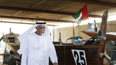 Emirati boat builder Ali Mattar Al Shamsi, 85, is photographed with one of his boats in his building yard in Ajman. Sarah Dea / The National