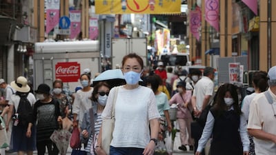 People wearing face masks to protect against the spread of the new coronavirus walk in Yokohama, near Tokyo. AP Photo