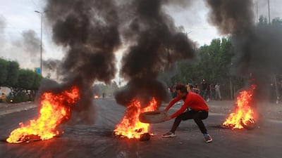 Anti-government protesters set fires and close a street during a demonstration in Baghdad, Iraq. AP Photo