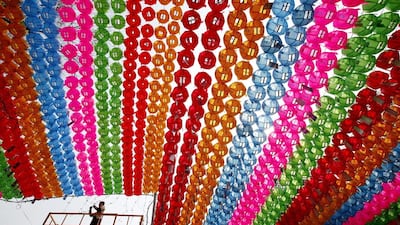 A South Korean Buddhist arranges lotus lanterns for decoration at Chogye temple in Seoul, South Korea. Jeon Heo-Kyun / EPA