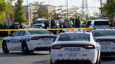 Police officers gather at the scene of a shooting in Mississauga, Ontario. All photos: AP