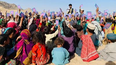 A Pen Path volunteer with school children.