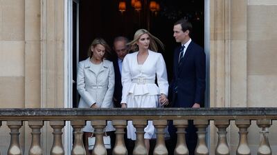 Ivanka Trump (2R) and her husband Senior Advisor to the President of the United States Jared Kushner (R) watch from a balcony at Buckingham Palace. AFP