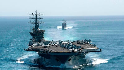 The USS Nimitz and the guided-missile cruiser USS Philippine Sea pass through the Strait of Hormuz on September 18, 2020. The aircraft carrier's deployment was extended on January 3, 2021 in the wake of threats from Iran on the first anniversary of the killing of Iranian military leader Qasem Soleimani. AP