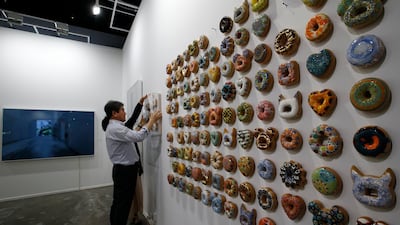 Exhibitors fix artwork 'Donut' by South Korean artist Kim Jae Yong during the 12th annual Art Dubai exhibition. EPA