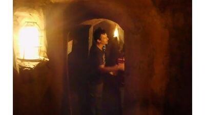 A tourist walks through tunnels underneath Jiaozhuanghu village that were developed to help guerrilla warfare efforts against Japanese forces.