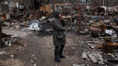 Olia, 53, stands next to destroyed constructions in her courtyard in Bucha on Tuesday. (Photo by Alexey Furman / Getty Images)