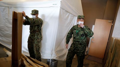 Japanese Self-Defence Forces soldiers work at a hotel that has been designated to accommodate asymptomatic people and those with light symptoms of the coronavirus disease to free up hospital beds, in Tokyo, Japan. Reuters