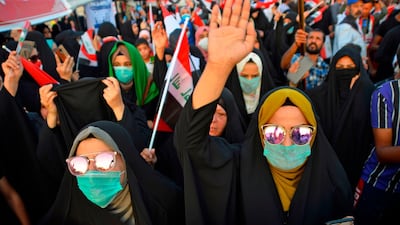 Iraqi women chant slogans and wave their country's national flag during during anti-government protests in the central Iraqi holy city of Najaf. AFP