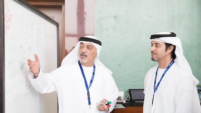 Sheikh Hazza bin Zayed, Vice Chairman of the Abu Dhabi Executive Council, right, with a participant at the symposium. Omar Al Askar for The Crown Prince Court - Abu Dhabi