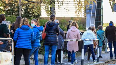 People line up outside a Covid testing facility set up in a school sports hall in Bolzano, South Tyrol, Northern Italy. AFP