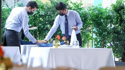 The terrace seating area of Cafe Milano at Expo 2020 Dubai, enveloped in greenery.
