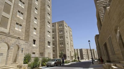 A Palestinian resident arrives at his new apartment. The organised layout and modern facilities are in jarring contrast to chaotic Palestinian towns and villages in the area.