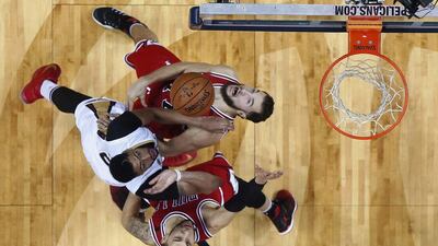 New Orleans Pelicans forward Anthony Davis battles under the basket with Chicago Bulls center Joffrey Lauvergne, top right, and guard Denzel Valentine, bottom right, in the second half of an NBA basketball game in New Orleans. Gerald Herbert / AP