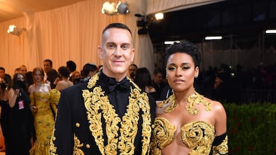 Actress, singer and dancer Ariana DeBose and fashion designer Jeremy Scott co-ordinate in black-and-gold Moschino designs. AFP