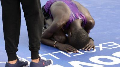 Lagos City Marathon winner Abraham Kipton of Kenya prays after crossing the finishing line on Saturday. AFP Photo