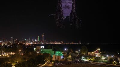 An image of Kuwait's Crown Prince Sheikh Mishal Al-Sabah hovers above Green Island during Independence day celebrations