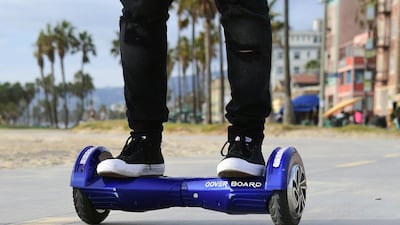A man uses his hoverboard on the Venice Beach Boardwalk. (AFP PHOTO/ FREDERIC J. BROWN)