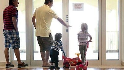 People try a locked beach-access door being locked at the Palm Shoreline residence complex. Residents have been blocked by the developer Nakheel from going to the beach adjacent to their apartment building. Silvia Razgova / The National