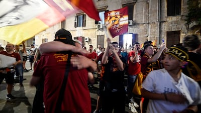 AS Roma fans watch outside the Testaccio Roma Club. EPA