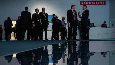 Attendees gather at the BAE Systems Plc stand. Bloomberg