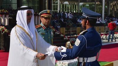 Sheikh Saif bin Zayed awards Sword of Honour to high-acheieving student, Mohammed Obaid Al Rashidi.