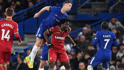Chelsea defender Gary Cahill leaps for a header over Swansea's Wilfried Bony. Andy Rain / EPA