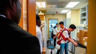 A team including Poly U management, security guards, councillors and the Hong Kong Red Cross search rooms for any remaining protesters hiding. AFP