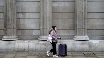 A pedestrian, wearing a protective face mask, walks near the Bank of England in the City of London. Bloomberg