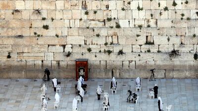 A small number of Jewish worshippers pray during the priestly blessing, a traditional prayer which usually attracts thousands of worshippers at the Western Wall on the holiday of Passover, amid the coronavirus disease outbreak, in Jerusalem's Old City. Reuters