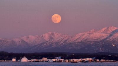 The moon rises over the Chugach Mountains in Anchorage, Alaska. Dan Joling / AP Photo.