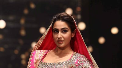 Sara Ali Khan presents a creation of designers Abu Jani and Sandeep Khosla during the Delhi chapter of the Blenders Pride Fashion Tour 2019-20 in New Delhi. AFP