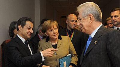 France's President Nicolas Sarkozy, Germany's Chancellor Angela Merkel and Italy's Prime Minister Mario Monti relax together prior to a meeting at the European Council in Brussels ahead of the European Union leaders summit yesterday, but there was little cheer at the meeting proper.