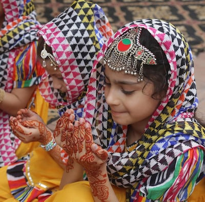 Pakistani girls, with their hands decorated with henna, pray during the Eid al-Adha holiday, in Lahore Pakistan, Wednesday, Aug. 22, 2018. Muslims around the world celebrate Eid al-Adha, or the Feast of the Sacrifice, that marks the willingness of the Prophet Ibrahim (Abraham to Christians and Jews) to sacrifice his son. During the holiday, which in most places lasts four days, Muslims slaughter sheep or cattle, distribute part of the meat to the poor and eat the rest. (AP Photo/K.M. Chaudary)