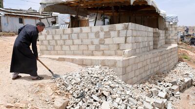 A Syrian refugee removes rubble as he dismantles his shelter at the Lebanese border town of Arsal, Lebanon. Reuters/Hassan Abdallah