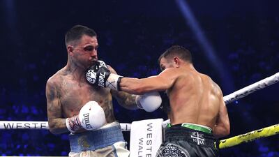 Kambosos, left, and Lomachenko trade shots. EPA