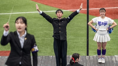 Dressed in old-fashioned school-style uniforms, the cheering groups are a mass of black at college baseball games as they chant, bang taiko drums and thrust their fists in rigid, martial moves