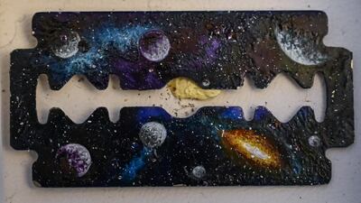 A landscape painted on a razor blade by Turkey's micro artist Hasan Kale in Istanbul.