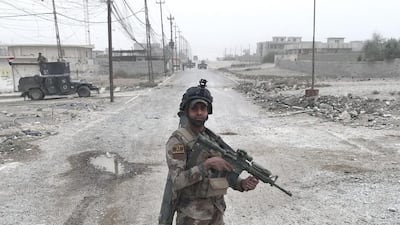 Bergam Kadhim, from Najaf, Iraq, an Iraqi special forces soldier, poses for a portrait on a street in Gogjali, an eastern suburb of Mosul.