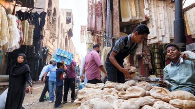 Bazaar street scene with child selling bread. Islamic Cairo, Egypt