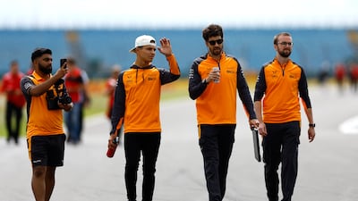 McLaren's Lando Norris walks with his team ahead. Reuters