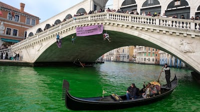 The water of the Grand Canal turns green after a protest by Extinction Rebellion climate activists in Venice. Reuters