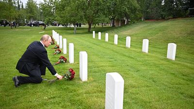 Russian President Vladimir Putin places flowers at the graves of Soviet soldiers at Fort Richardson National Cemetery in Anchorage, Alaska. Reuters