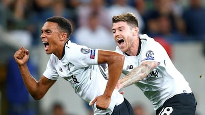 Liverpool's Trent Alexander-Arnold, left, celebrates scoring his team's first goal against Hoffenheim on Tuesday night. Ralph Orlowski / Reuters