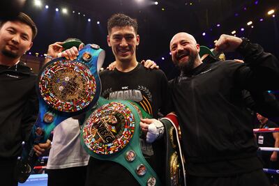 Dmitry Bivol celebrates victory with his four belts. Getty Images