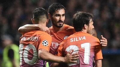 Manchester City’s Sergio Aguero, left, Ilkay Gundogan, centre, and David Silva celebrate the equalising third goal. Oli Scarff / AFP
